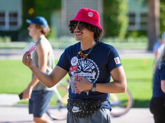 Destination Arizona Leader, Yassine, passes out free DAZ merch. 