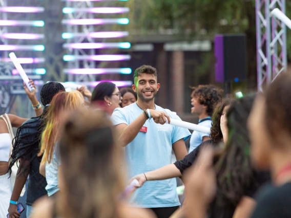 Destination Arizona Leader, Omar, smiles through the crowd of dancing students at Evening Oasis.