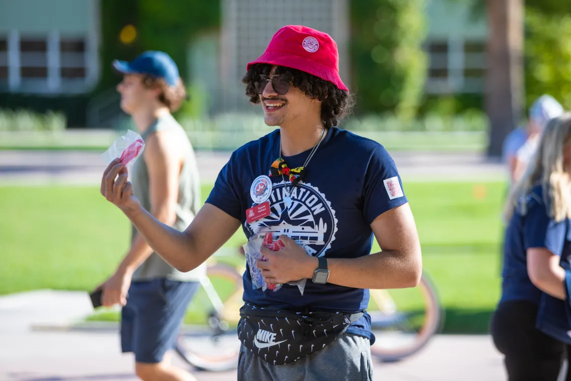 Destination Arizona Leader, Yassine, passes out free DAZ merch. 