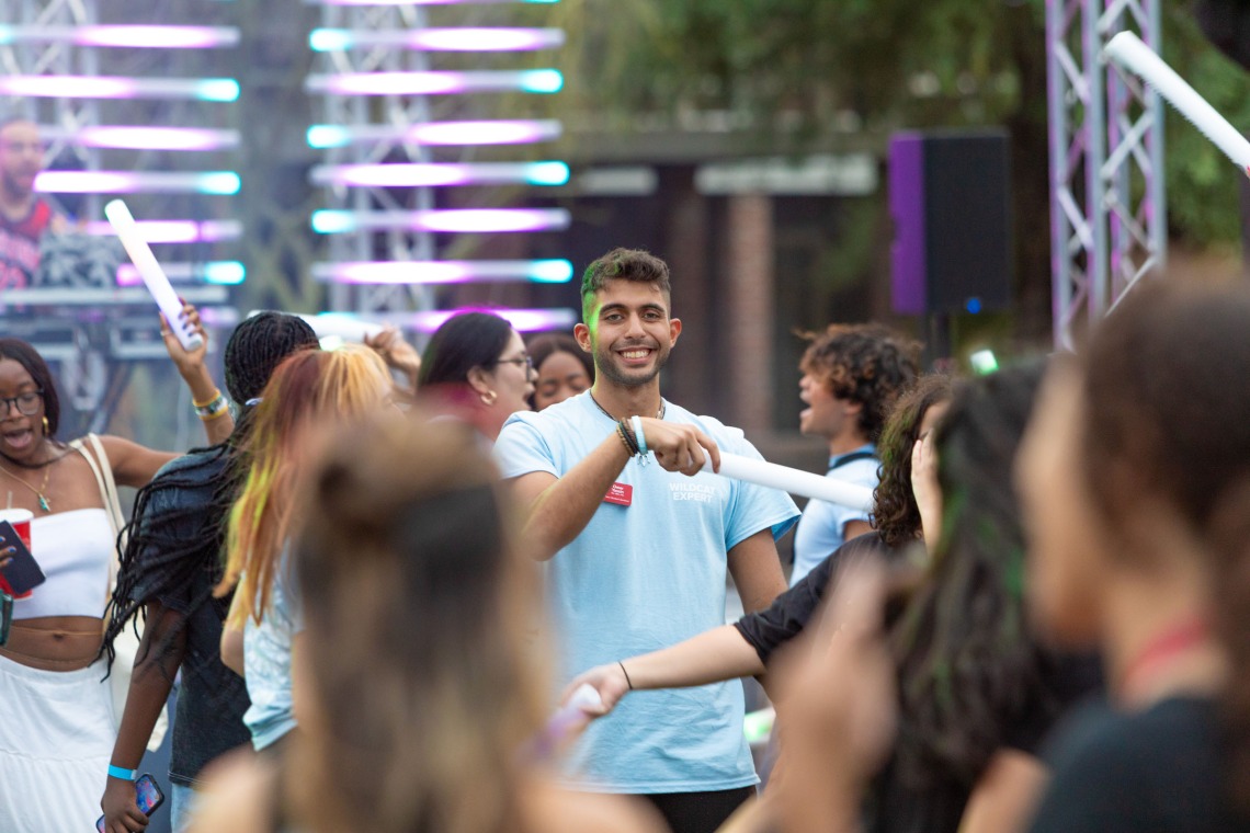 Destination Arizona Leader, Omar, smiles through the crowd of dancing students at Evening Oasis.
